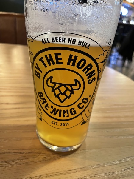 Image of a pint glass branded with By the Horns logo